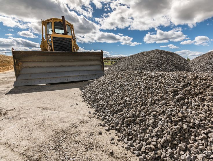 Stockpile of construction aggregates and heavy equipment in our yard